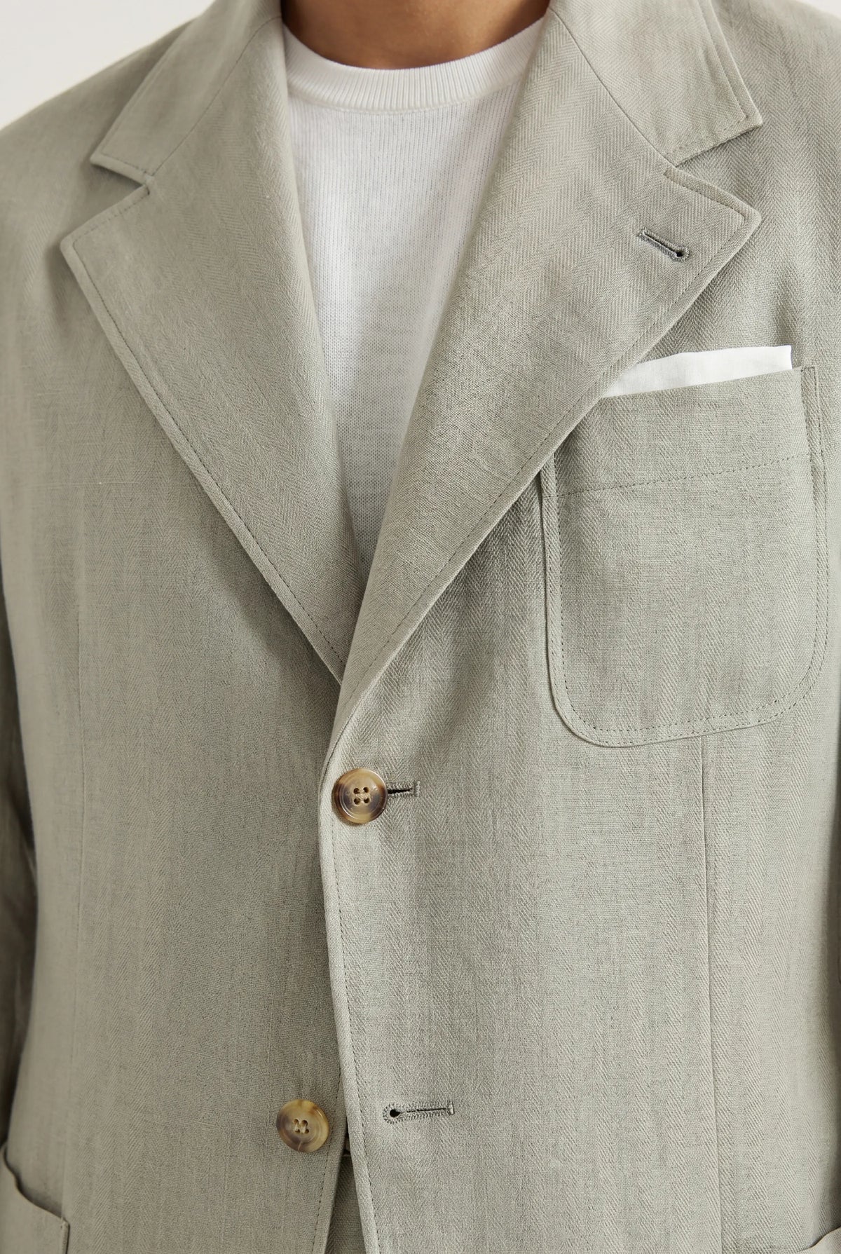 Zane Barläs Sage Linen Herringbone Jacket. Editorial portrait view in sage linen tailoring