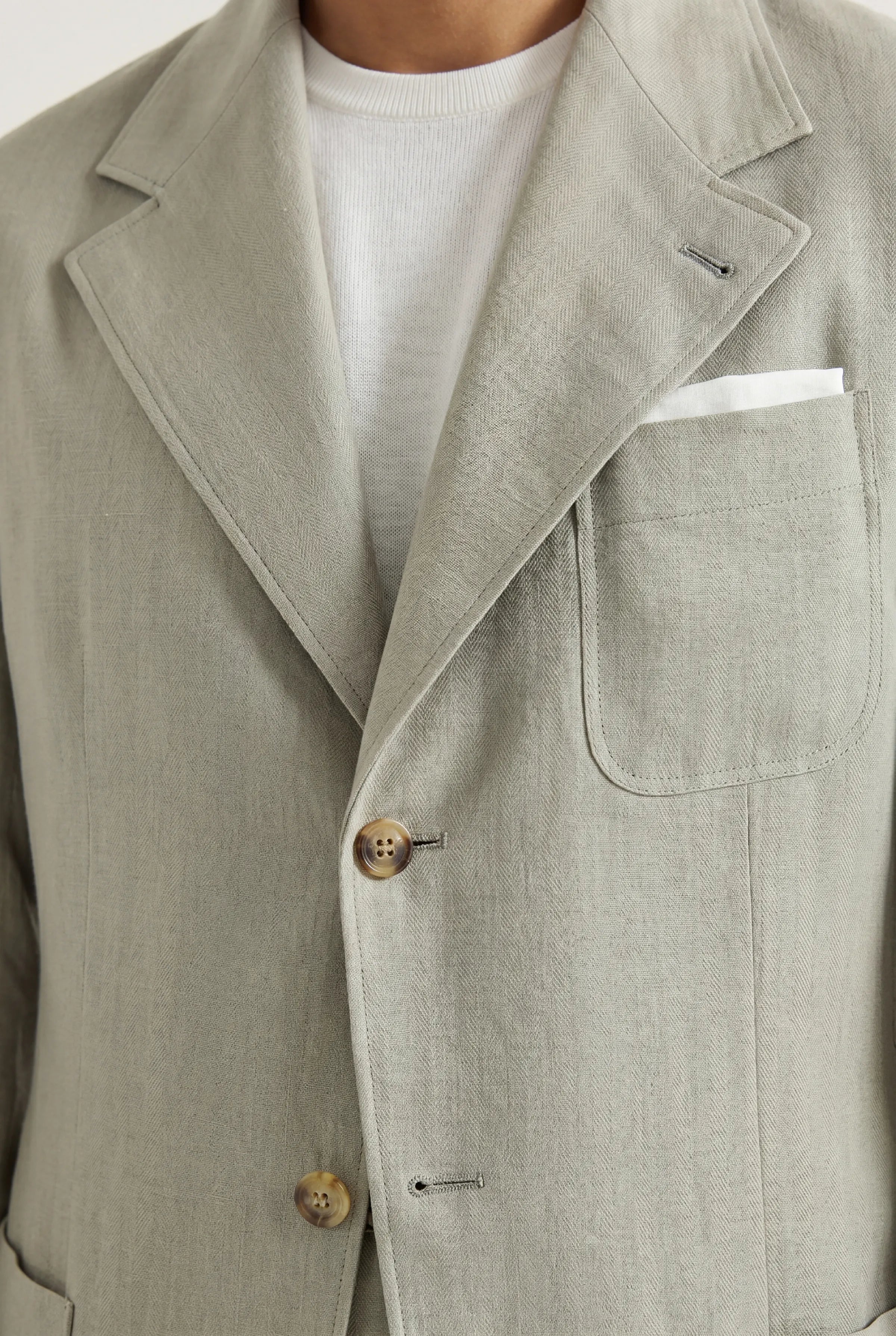 Zane Barläs Sage Linen Herringbone Jacket. Editorial portrait view in sage linen tailoring